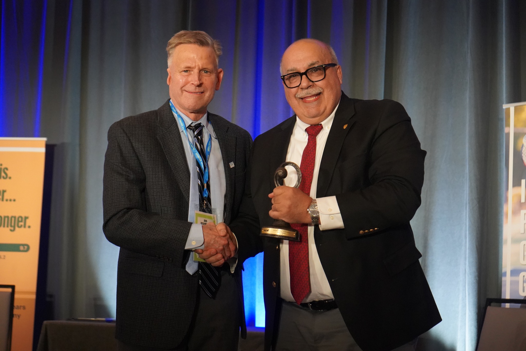 Paul Farah (right) accepting the Mel Bergman - Section Diamond Service Award from USTA Midwest Board President, Jeff Stassen (left).